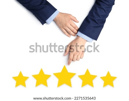 Quality evaluation. Businessman pointing at virtual golden stars on white background, closeup