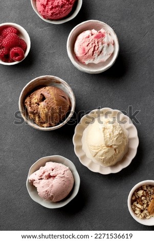 bowls of various ice creams on grey table, top view