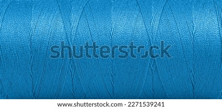 Texture of threads in a spool of blue color on a white background close-up Royalty-Free Stock Photo #2271539241