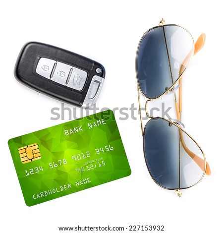 Car key with remote control, sunglasses and credit card, isolated over white background