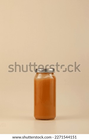 Fruit puree in tall glass jar with metal lid. Baby food, the first complementary food. Design element, copy space. Royalty-Free Stock Photo #2271544151