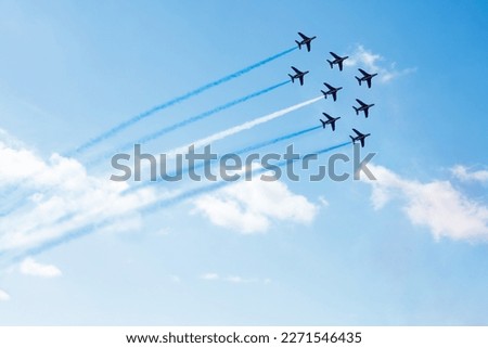 Squadron of planes fly with color trail lines of Finland Israel Greece Honduras Argentina Micronesia Guatemala or El Salvador over clouds and clear sky Royalty-Free Stock Photo #2271546435
