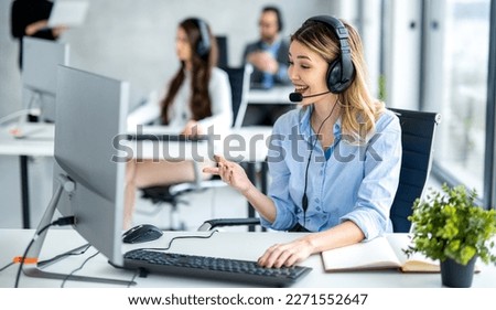 Dedicated female helpdesk service agent talking with client at call center. Royalty-Free Stock Photo #2271552647