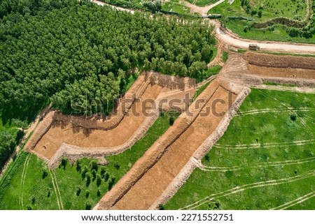 Removal of the top layer of earth overburden for the development of a sand pit, aerial view