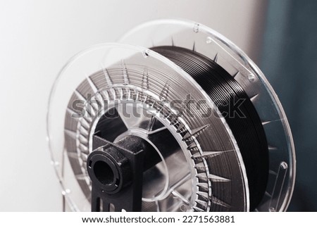 3d printing technology. 3d printing filament background.Black PLA wire in a roll. Home modern technology. Royalty-Free Stock Photo #2271563881