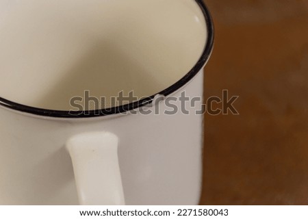 A white mug with a fragment flying away