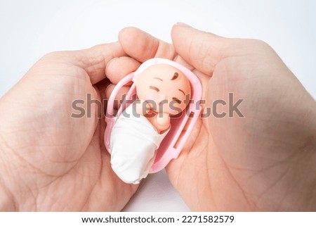 An image of gently wrapping a baby.