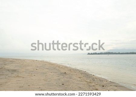 Lombok and Gili Air islands, overcast, cloudy day, sky and sea. Vacation, travel, tropics concept, no people. Sunny day, sand beach. Royalty-Free Stock Photo #2271593429