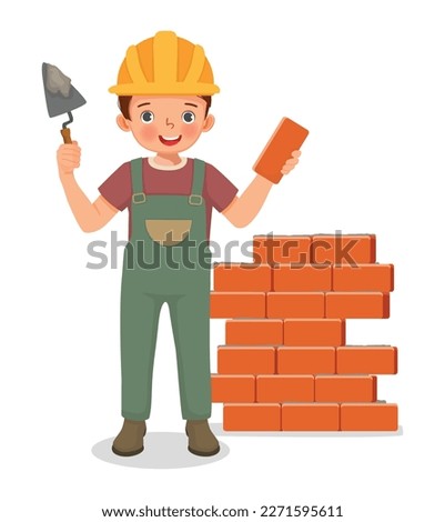 Cute little boy builder holding cement bricklayer tool working at the construction site