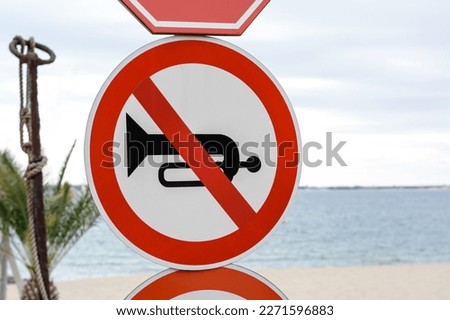 Post with No Horn traffic sign near sea outdoors