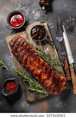 hot grilled spare ribs BBQ served fresh tomatoes. Restaurant menu, dieting, cookbook recipe top view. Royalty-Free Stock Photo #2271610311