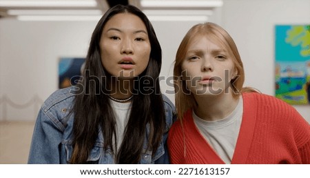 Portrait of two girls exploring art at an exhibition. Modern fine arts museum. Model and property released Royalty-Free Stock Photo #2271613157