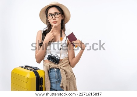 Happy Asian woman traveler with luggage, camera, passport and boarding pass ticket isolated on white background, Tourist girl having cheerful holiday trip concept.