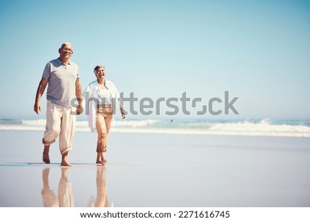 Holding hands, summer and an old couple walking on the beach with a blue sky mockup background. Love, romance or mock up with a senior man and woman taking a walk on the sand by the ocean or sea Royalty-Free Stock Photo #2271616745