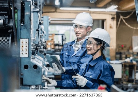 Technical staff working while checking their tablet devices Royalty-Free Stock Photo #2271637863
