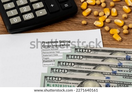 Crop insurance premium bill with soybeans and corn. Concept of grain yield loss, hail and wind field damage and farm income protection. Royalty-Free Stock Photo #2271640161