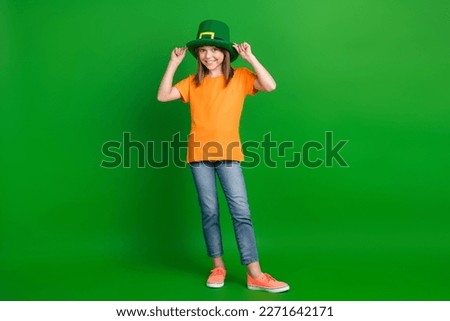 Full body portrait of cheerful positive person arms touch st patrick hat isolated on green color background