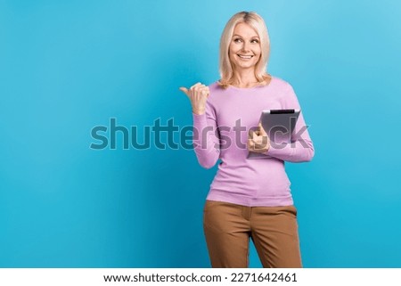 Photo of retired aged real estate agent lady recommend new apartments proposition finger mockup hold tablet isolated on blue color background