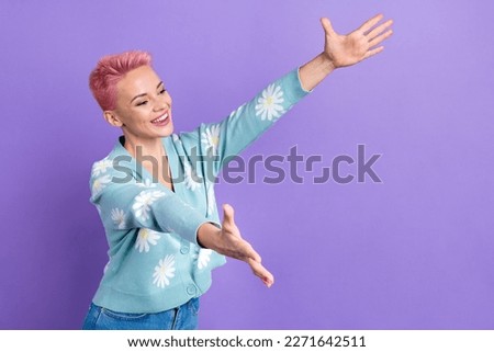 Photo of optimistic satisfied woman short hairstyle dressed blue cardigan look empty space hug you isolated on purple color background