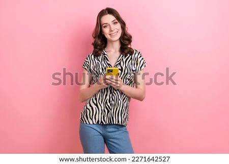 Photo of famous curly brown hair blogger young girl wear stylish zebra print blouse hold smartphone chatting isolated on pink color background