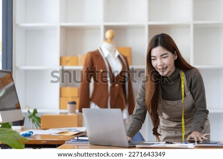 Fashion designer in design studio working with laptop and fabric color samples on desk. Entrepreneurship Ideas Starting a Small Business