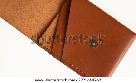 Orange empty men's business handmade leather card holder with isolated on white background. Selective focus, copy space, close up.