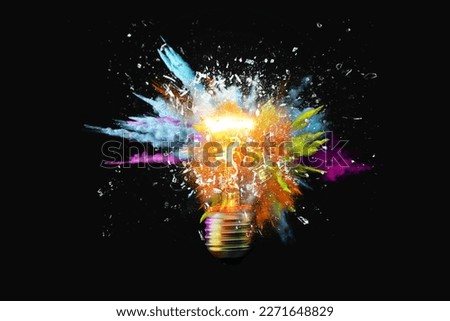 Creative light bulb explodes with colorful paint splashes and shards of glass on a black background. Think differently creative idea concept. Dry paint splatter. Brainstorm and think Royalty-Free Stock Photo #2271648829