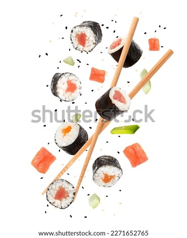 Sushi rolls and wooden chopsticks flying on white background Royalty-Free Stock Photo #2271652765