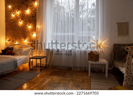 Cozy bedroom with stylish Christmas decor. Interior design