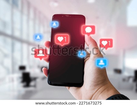 man using smartphone with social media icons pop up, blurred bright office background, social media, social network concept