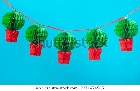 Manjerico paper garland against the blue background. Traditional Summer festival in June San Juan, Portugal Royalty-Free Stock Photo #2271674565