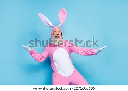 Photo of positive charming man pensioner dressed pink rabbit nightwear dancing smiling isolated blue color background Royalty-Free Stock Photo #2271680185