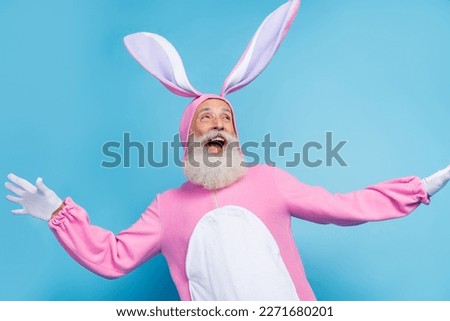 Photo of funky excited retired guy wear pink hare sleepwear looking empty space isolated blue color background