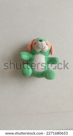 Green dog doll isolated on the floor