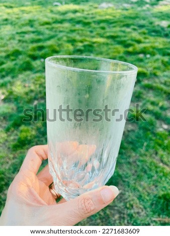 A drinking glass which has become cloudy and damaged from being washed in the dishwasher repeatedly Royalty-Free Stock Photo #2271683609