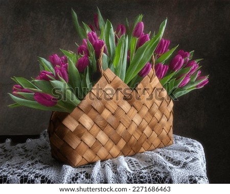 Still life with a basket of purple tulips