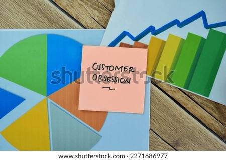Concept of Customer Obsession write on sticky notes isolated on Wooden Table.