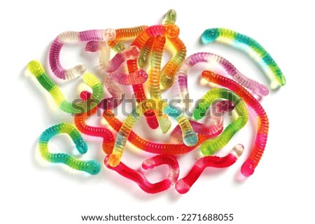 Colorful gummy jelly worm candies on white background, top view