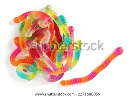 Top view of colorful gummy worms on white background