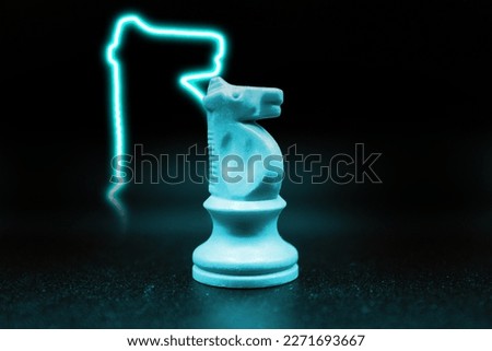 blue cyan knight with led in the shape of a knight. close up photo with black background. chess piece illustration. creative photo. glow