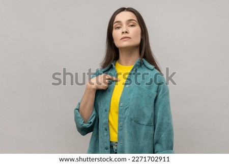 Confident egoistic woman pointing on herself with arrogance and satisfaction, proud of herself, bragging with achievements, wearing casual style jacket. Indoor studio shot isolated on gray background. Royalty-Free Stock Photo #2271702911