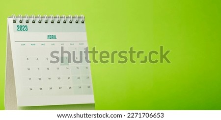 Desk calendar for the month of April 2023 with bright green background Royalty-Free Stock Photo #2271706653