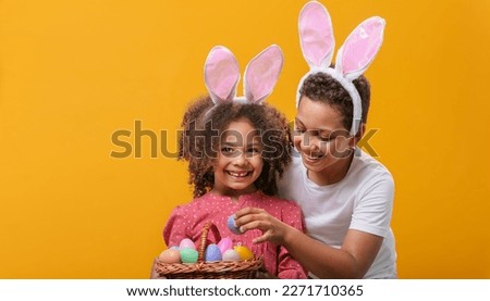 Children with a basket full of eggs are getting ready to celebrate the Easter holiday Royalty-Free Stock Photo #2271710365