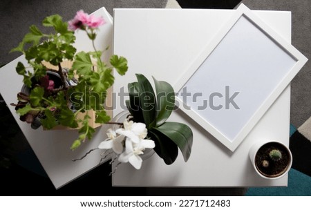 Blank picture frame on a white table in the living room. Royalty-Free Stock Photo #2271712483