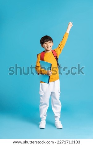 Portrait of Asian school boy born on a blue background Royalty-Free Stock Photo #2271713103