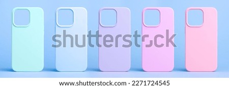 set of five back covers for mobile phone in different colors isolated on light blue background, phone case mock up for iPhone 13 Pro Max and 14 Plus