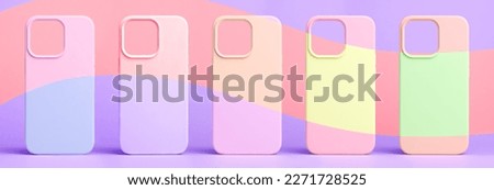 set of five back covers for mobile phone in different colors isolated on purple and half part painted in pink background, phone case mock up for iPhone 13 Pro Max and 14 Plus