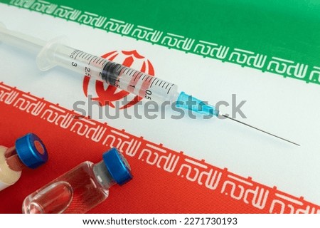 Pharmacology and Medicine iran concept. vaccine against coronavirus covid. Vaccine ampoules, syringe against the background of national flag. national pharmacological industry.