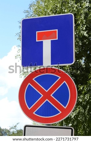 Different road signs on city street. Traffic rules