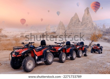 Safari trip ATV quad bike with set colorful hot air balloon in Cappadocia Goreme Turkey.